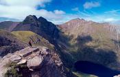 Walker looking out from the An Teallach ridge, Wester Ross, Scotland.