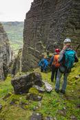 Hikers nearing the bottom of Annach Re Mhor chasm, Kings Mountain, County Sligo, Ireland.