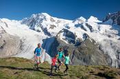 Family hiking beneath Monte Rosa, Gornergrat, Zermatt, Switzerland.