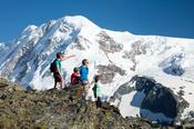 Family hiking beneath Monte Rosa, Gornergrat, Zermatt, Switzerland.