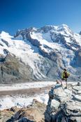 Hiker beside Gorner Glacier and Monte Rosa, Gornergrat, Zermatt, Switzerland.