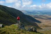 Walker above the North Prison of Lugnaquilla, Wicklow Mountains, County Wicklow, Ireland.