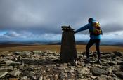 Walker at the summit of Lugnaquilla (925m), Wicklow Mountains, County Wicklow, Ireland.