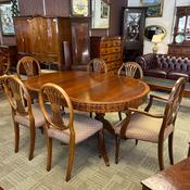 Elegant Regency-style mahogany dining table with six matching chairs