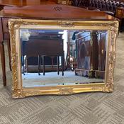 Large ornate gilt-framed wall mirror