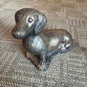 Stone, sausage dog, with a bronzed or antiqued metallic finish ornament