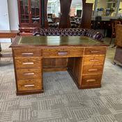 Substantial traditional oak writing desk with a green tooled leather top image