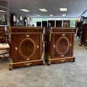 Pair of French Louis XVI–style mahogany cabinets with ornate gilt detailing