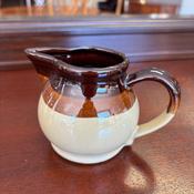 Vintage 1970s stoneware milk jug with a brown and beige tones