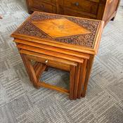 Nest of 4 tables features intricate hand-carvings and brass or bone floral inlay