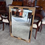 Rectangular wall mirror with a decorative gilt and black frame image