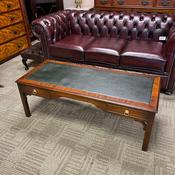 Elegant mahogany coffee table featuring a green leather top image