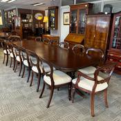 A stunning large mahogany extending dining table complete with 14 chairs