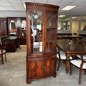 Impressive mahogany display corner cabinet with a beautifully curved bow-front image