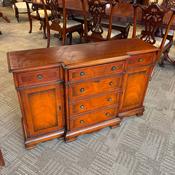 Yew wooden flamed breakfront sideboard.