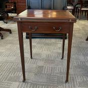 Edwardian mahogany games envelope table, with drawer