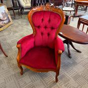 Victorian mahogany armchair with a carved, deep button-back upholstery in red