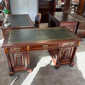 Classic antique wooden twin pedestal desk with a dark green image