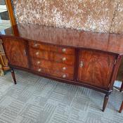 Vintage mahogany flamed sideboard featuring a distinctive bow front image