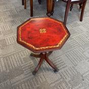 Vintage Regency-style octagonal wine table featuring a gilt-embossed oxblood top image