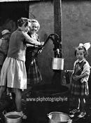 Girls at water pump