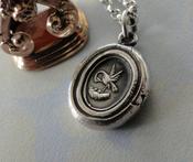 Pelican in her piety, parenthood necklace.  Family pendant, mother nurturing her young. Silver Mother or father gift,  chicks in a nest. image